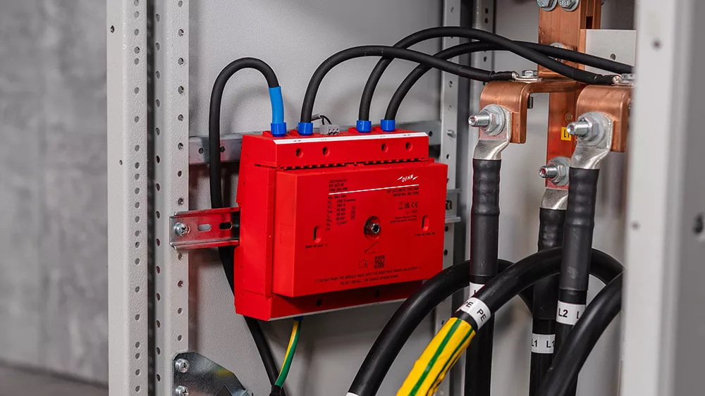 A red box with multiple wires connected to it, showcasing an electronic component setup.